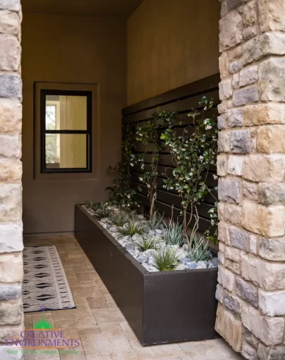 Custom entryway with living wall and natural stone pillars.