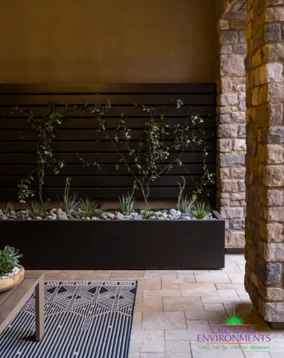 Custom backyard design with living wall, natural stone columns and outdoor seating area.