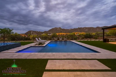 Custom backyard design with pool, Jesus steps and artificial turf.