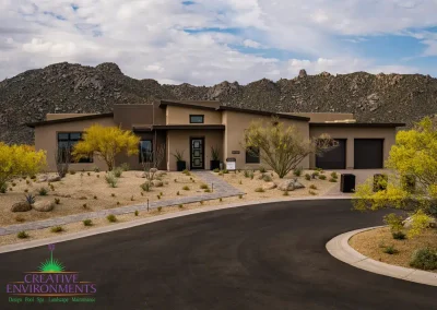 Custom front yard design with organized planting, roundabout and natural stone walkway.