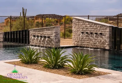 Custom backyard design with multiple water features, pool and desert landscape design.