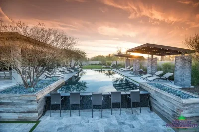 Custom backyard design with multiple seating areas, large planters and cantilevered shade structure.