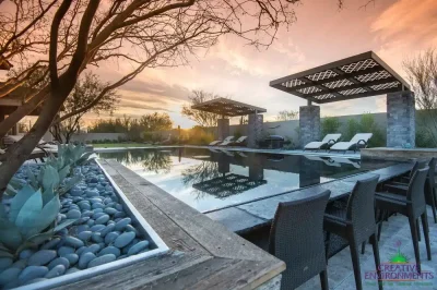 Custom backyard design with cantilevered shade structure, large planters and zero-edge pool.