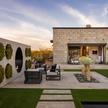 Backyard design with circular living wall, multiple seating areas and artificial turf.