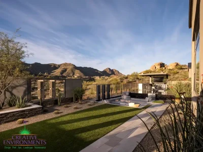 Backyard design with desert plants and artificial turf.