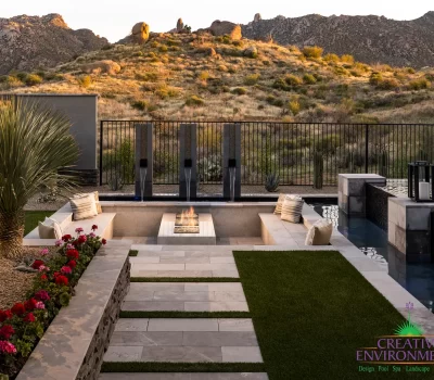 Backyard design with sunken fire feature and natural stone steps.