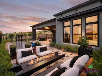 Custom backyard design with deco-tile decking, cantilevered fire table and multiple seating areas.