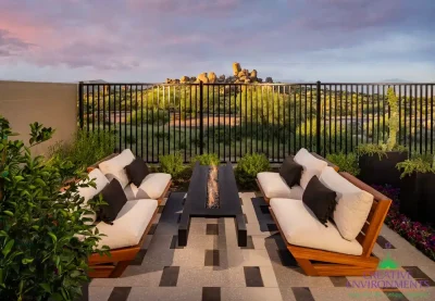 Custom backyard design with floating fire table, metal fencing and outdoor seating area.