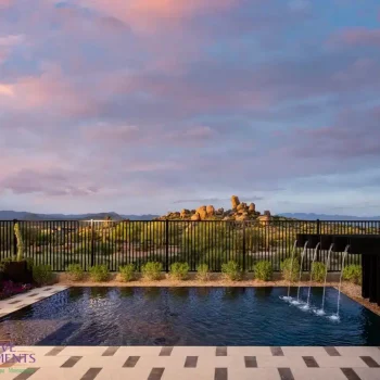 Custom backyard design with deco-tile decking, metal scupper water feature into pool and large planters.