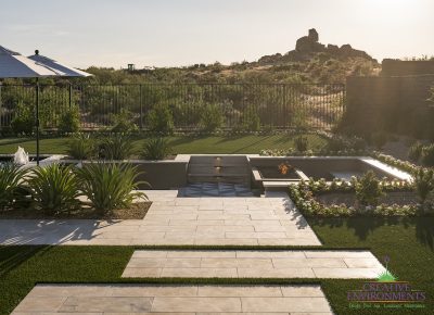 Custom backyard design with mountain views, annuals and step lighting.