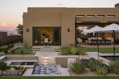 Custom backyard design with sunken fire pit, deco-tile flooring and pool.