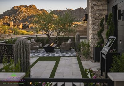 Custom front yard design with deco-tile flooring, fire table and cacti.