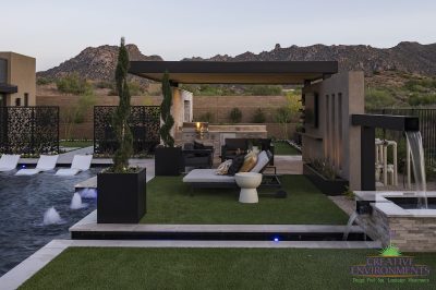 Custom backyard design with large planters, bubblers and custom metal dividers.