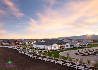 Custom community entrance with organized planting, real grass and roundabout driveway.