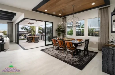 Custom indoor/outdoor fusion with outdoor fan, outdoor kitchen and multiple seating areas.