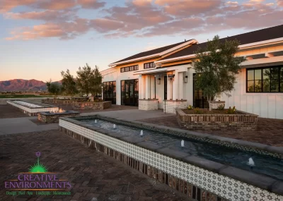 Custom community amenities with linear water features, fire pit and clubhouse.