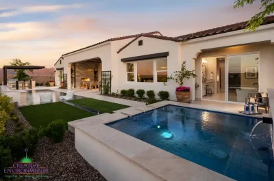 Custom backyard design with natural stone spa, metal trellis and cantilevered shade structure.