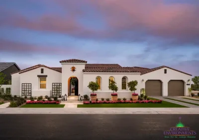 Custom front yard design with large planters, metal trellis, and mixed materials driveway with natural stone and artificial turf.