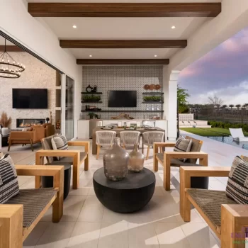 Custom indoor/outdoor fusion with wooden ceiling beams, multiple seating areas and pool with baja step.