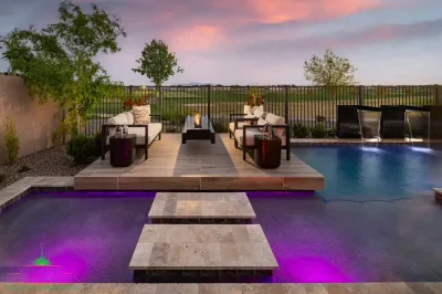 Custom backyard design with Jesus steps, floating fire table and metal scupper water feature into pool.