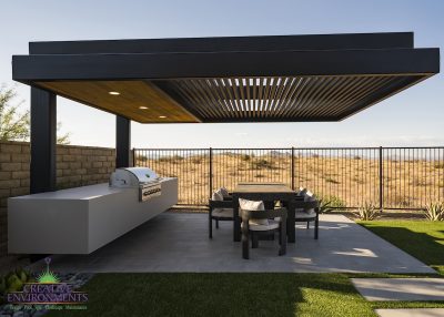 Custom backyard design with cantilevered shade structure, built-in BBQ and outdoor dining area.