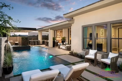 Custom backyard design with zero-edge pool, multiple seating areas and planters.