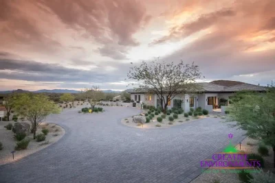 Custom roundabout driveway with pavers and desert plants.