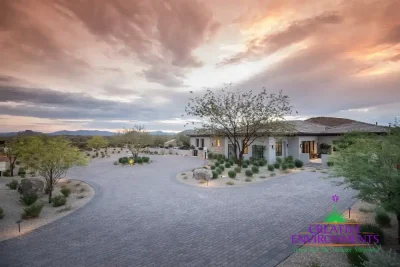 Custom roundabout driveway with pavers and desert plants.