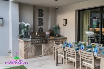 Custom outdoor patio with outdoor BBQ, dining area and indoor/outdoor fusion.