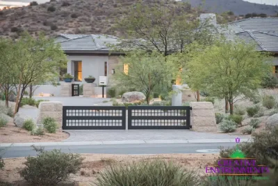 Custom front yard design with metal entry gate with wok planters and desert plants.