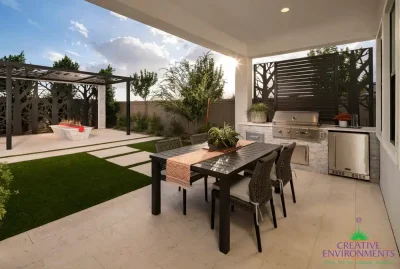 Custom backyard design with custom metal cutouts and outdoor kitchen.