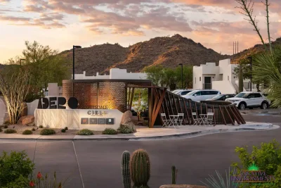 Custom community entrance with metal sign, unique metal statement piece and outdoor dining area.