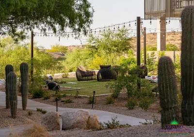 Custom community area with string lights, pathway and real grass.