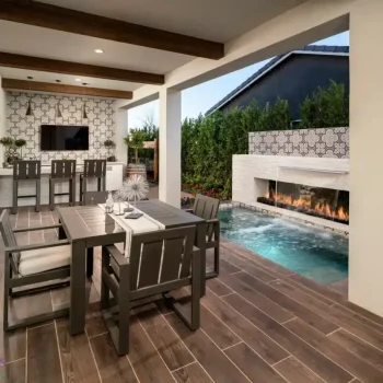 Custom backyard design with deco-tile backsplash, bar seating and outdoor dining area.