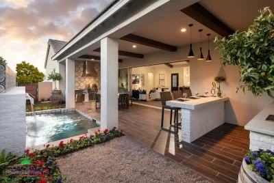 Custom backyard design with wooden ceiling beams, water feature and organized planting.