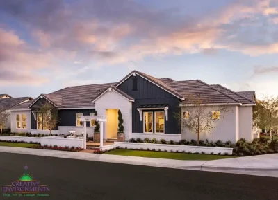 Custom front yard design with white wall, archway and artificial turf.