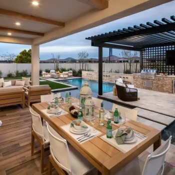 Backyard design with slatted metal shade structure, outdoor kitchen and multiple seating areas