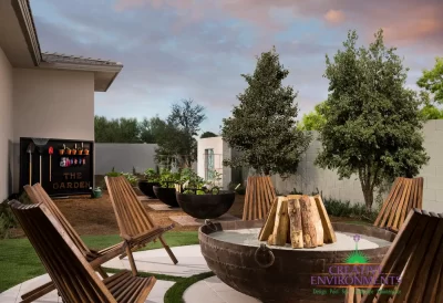Custom backyard design with gardening corner, wok planters and wok fire pit.