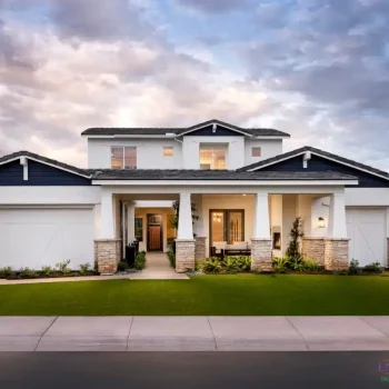 Custom front yard design with artificial turf, tree lighting and organized planting.