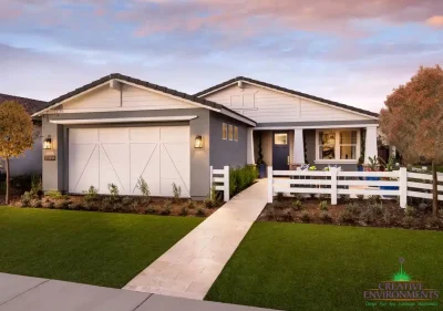 Custom front yard design with organized planting, artificial turf and natural stone tile pathway.