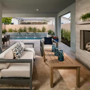 Custom backyard design with deco-tile pool wall, fireplace and organized planting.