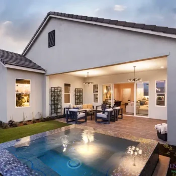 Custom backyard design with metal trellis, blue spa and outdoor dining area.