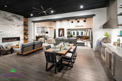 Custom indoor/outdoor fusion with outdoor shelving, multiple seating areas and floor-to-ceiling marble fireplace.