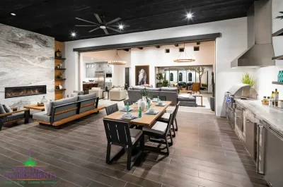 Custom indoor/outdoor fusion with outdoor shelving, multiple seating areas and floor-to-ceiling marble fireplace.