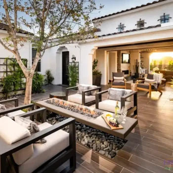 Custom entryway courtyard with fire table, metal trellis and multiple seating areas.