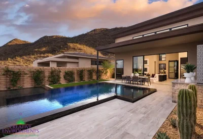 Custom travertine decking, cacti and metal trellis with ivy.