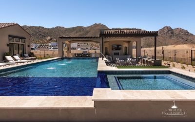 Custom backyard design with two-story shade structure, resort-style pool and raised spa.