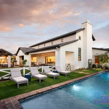 Custom backyard design with artificial turf, traditional blue pool and organized planting.