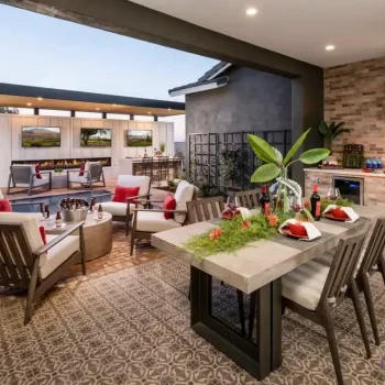 Custom backyard design with multiple seating areas, outdoor kitchen and cantilevered shade structure with multiple outdoor TVs.