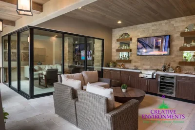 Custom backyard design with outdoor shelving, outdoor kitchen and multiple seating areas.